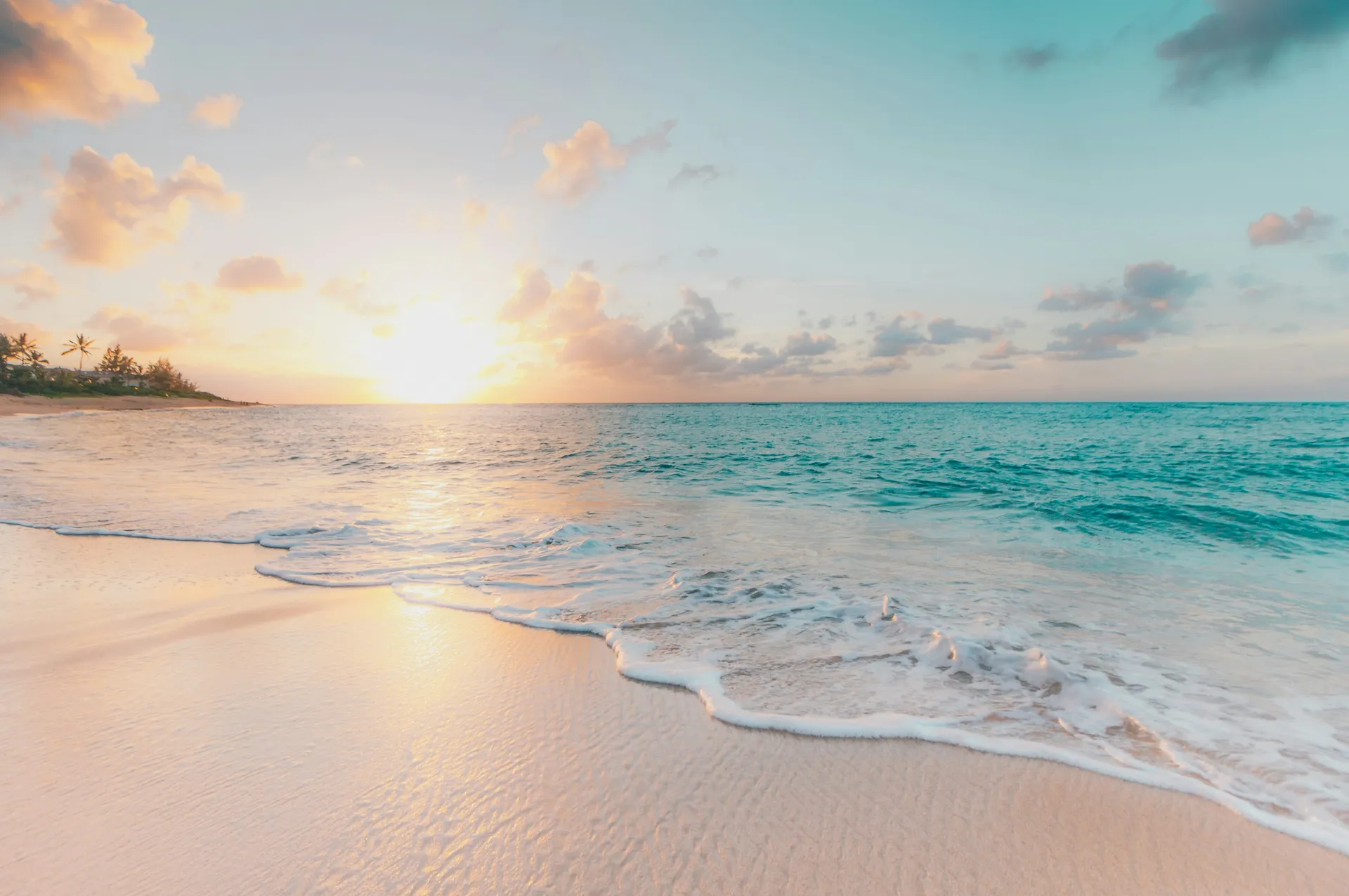 Warm Caribbean beach and turquoise water at sunset